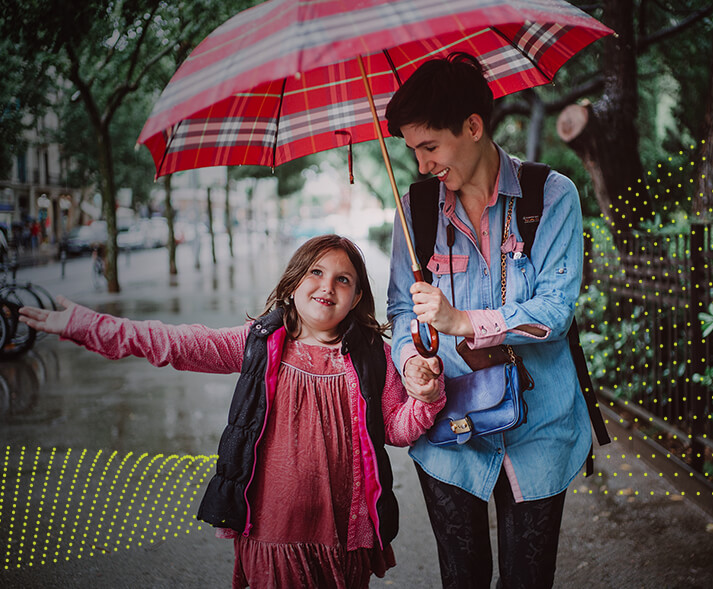 Woman and child walking with an umbrella